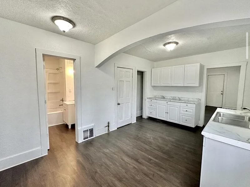 Kitchen after: white cabinets, new counters and new flooring